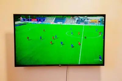 a flat screen tv hanging on a wall at Ezma-homes in Boma la Ngombe