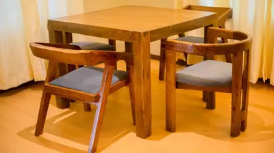 a wooden table with two chairs and a wooden table and stool at The Valley Retreat in Arusha