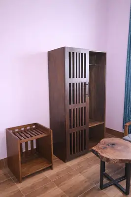 a room with a wooden cabinet and a table at The Valley Retreat in Arusha