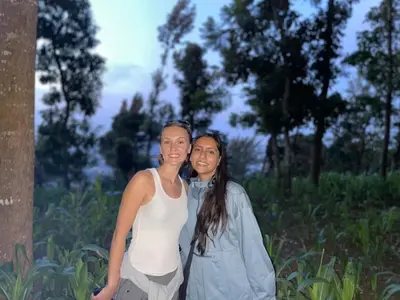 two women standing next to each other in a field at KidotuiVillaHome in Arusha