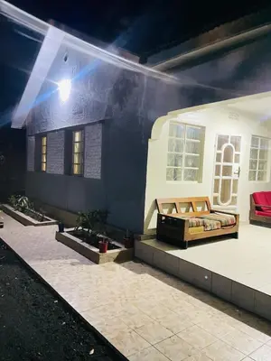 a room with a bed on the side of a house at KidotuiVillaHome in Arusha