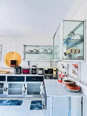 a kitchen with white cabinets and a counter top at KL shadow homes in Arusha