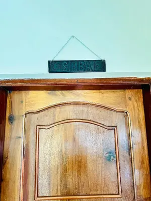 a street sign on top of a wooden door at KL shadow homes in Arusha