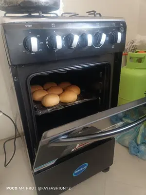 an oven with some food inside of it at Five Zones - Private 4-Bedroom Holiday Home in Moshi