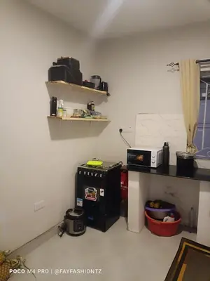 a room with a kitchen with a counter and a microwave at Five Zones - Private 4-Bedroom Holiday Home in Moshi