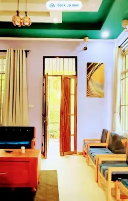 a living room with a couch and a door at Kilimanjaro Forest Lodge and Camping Site in Mdawi