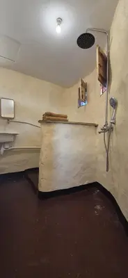 a bathroom with a shower and a sink at Lake Natron Maasai Boma-Unique Stay in Mtowabaga