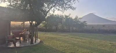 a person riding a horse drawn carriage in a field at Lake Natron Maasai Boma-Unique Stay in Mtowabaga