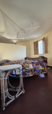 a room with a bed and a table in it at Lake Natron Maasai Boma-Unique Stay in Mtowabaga