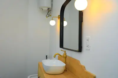 a bathroom with a sink and a mirror at Heart Of Africa Lodge Acacia in Mkulat