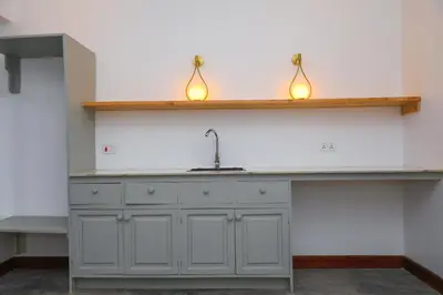 a kitchen with a sink and two lights on a counter at Heart Of Africa Lodge Acacia in Mkulat