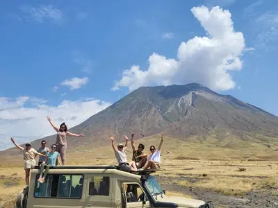 a group of people standing on the top of a vehicle at Morris Eco Safaris in Arusha