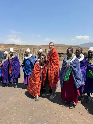 a man standing in front of a group of people at Morris Eco Safaris in Arusha
