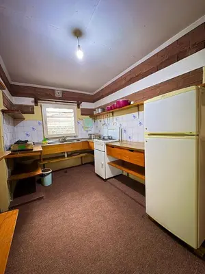 a kitchen with a white refrigerator and wooden counters at NgareSero Haven - Eco 3BR Home with Garden and Farm in Usa River