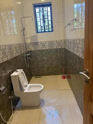 a bathroom with a toilet and a shower at Safari Haven Villa in Moshi