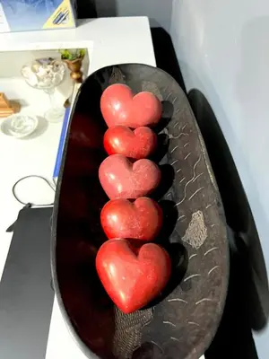 a group of red hearts in a pan on a counter at Esther Villas Home in Boma la Ngombe