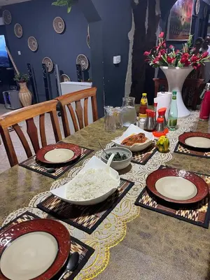 a table with plates of food on top of it at Esther Villas Home in Boma la Ngombe