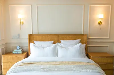a bedroom with a large bed with white pillows at French Unit - ground floor sleeps 2 in Arusha