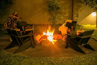 a fire pit with two chairs in front of it at French Unit - ground floor sleeps 2 in Arusha