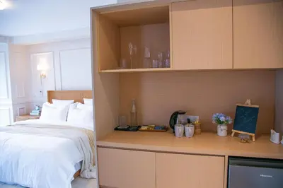 a hotel room with a bed and a desk and shelves at French Unit - ground floor sleeps 2 in Arusha