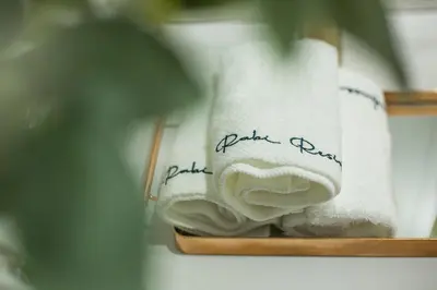a pair of towels with the words better bathrooms written on them at French Unit - ground floor sleeps 2 in Arusha