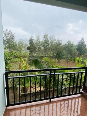 a balcony with a view of a garden at Tulivu Nyumba in Arusha