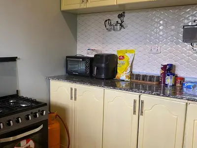 a kitchen with a counter top with a microwave at Tulivu Nyumba in Arusha