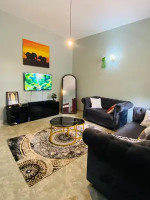 a living room with a couch and a table at Tulivu Nyumba in Arusha