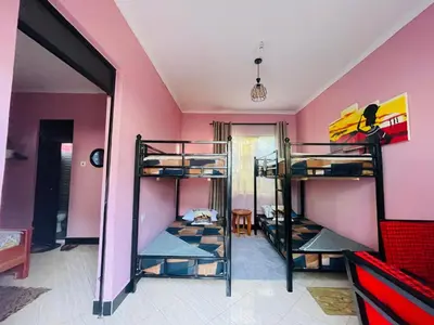 a room with three bunk beds in a room at Moshi -Mnazi home stay in Moshi
