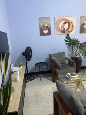 a living room with blue walls and a couch at Cozy and stylish apartment in Arusha Town in Arusha