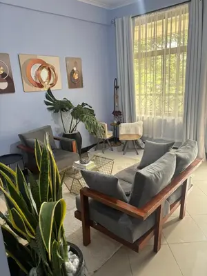 a living room with a couch and a table at Cozy and stylish apartment in Arusha Town in Arusha