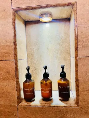a picture of two bottles of soap in a mirror at Sereni Homes in Arusha