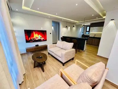 a living room with a couch and a fireplace at Sereni Homes in Arusha