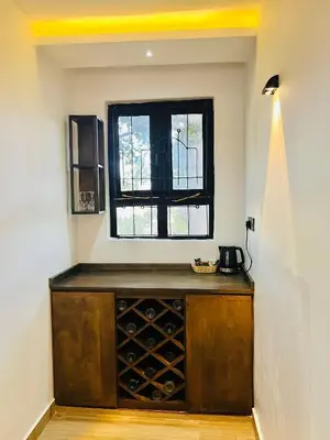a room with a wooden wine cellar with a window at Sereni Homes in Arusha