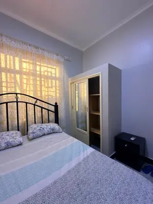 a bedroom with a large bed and a window at Kilimanjaro Peponi Villas in Msaranga