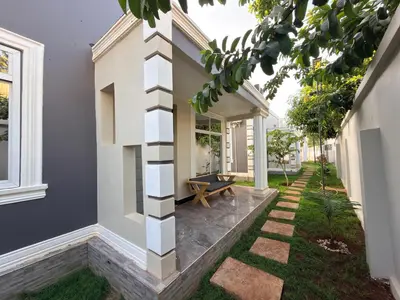 a house with a courtyard with a bench at Kilimanjaro Peponi Villas in Msaranga