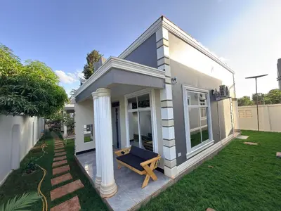 a small house with a bench on the front yard at Kilimanjaro Peponi Villas in Msaranga