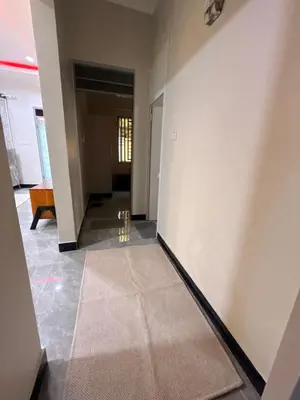 a hallway with white walls and a tile floor at Kilimanjaro Peponi Villas in Msaranga