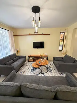 a living room with a couch and a table at Singi Homes in Nkunjila