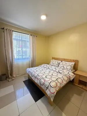 a bedroom with a bed and a large window at Singi Homes in Nkunjila
