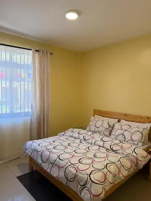 a bedroom with a bed in a room with a window at Singi Homes in Nkunjila