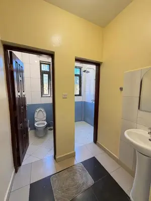 a bathroom with a toilet and a sink at Singi Homes in Nkunjila