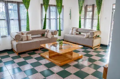 a living room with two couches and a coffee table at Noric Homes and Adventure in Msaranga
