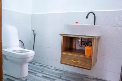 a bathroom with a toilet and a sink at Noric Homes and Adventure in Msaranga