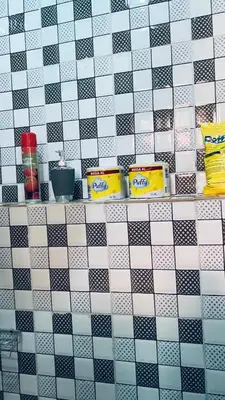 a tiled wall with a shelf in a bathroom at Osim Lodge City Centre in Arusha