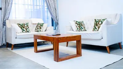 a living room with two couches and a coffee table at AG Comfort Safari Homes in Arusha