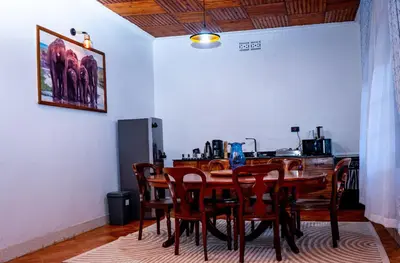 a dining room with a wooden table and chairs at AG Comfort Safari Homes in Arusha