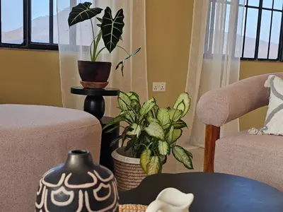 a living room with a chair and a plant at Villa Miamba in Zame