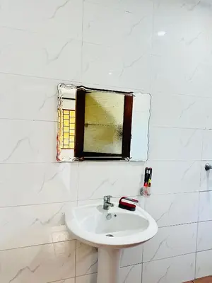 a bathroom with a sink and a window at KL shadow Homes in Arusha