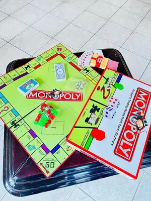 a monopoly board game sitting on top of a table at KL shadow Homes in Arusha